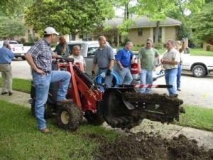 the sprinkler installation team takes a break from a trenching job