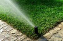 a quarter circle spray head covers the corner of an Arlington lawn