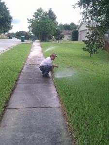 a sprinkler head adjustment being made