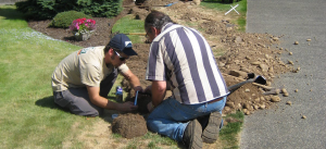 a team of Texas sprinkler installers putting in a new line